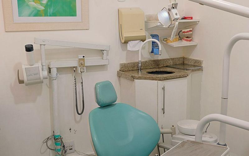 Consultório odontológico com cadeira e equipamento